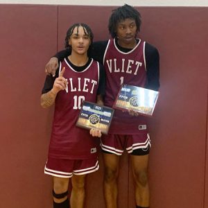 Two Watervliet basketball players in uniform stand side by side holding MVP and All Star plaques.