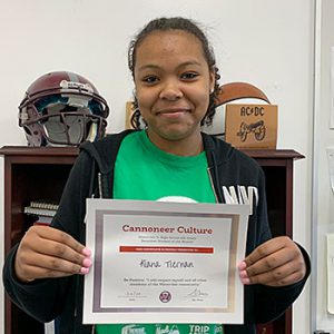 Be Positive grade 8 student of the month holds award certificate and smiles at camera