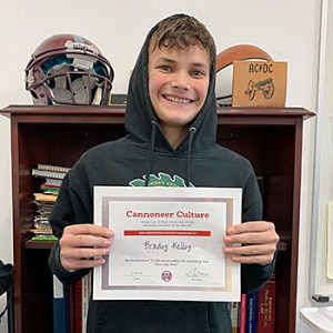 Be Productive grade 8 student of the month holds award certificate and smiles at camera