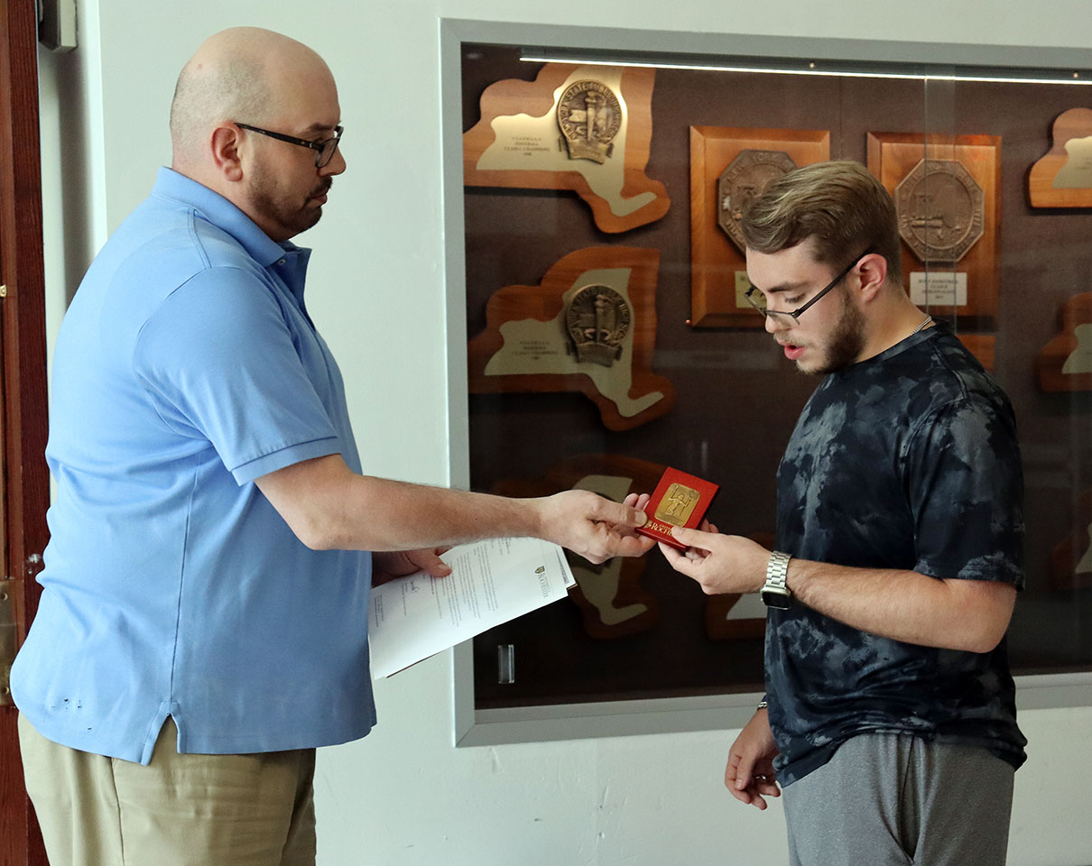 Teacher presents science scholarship award to student