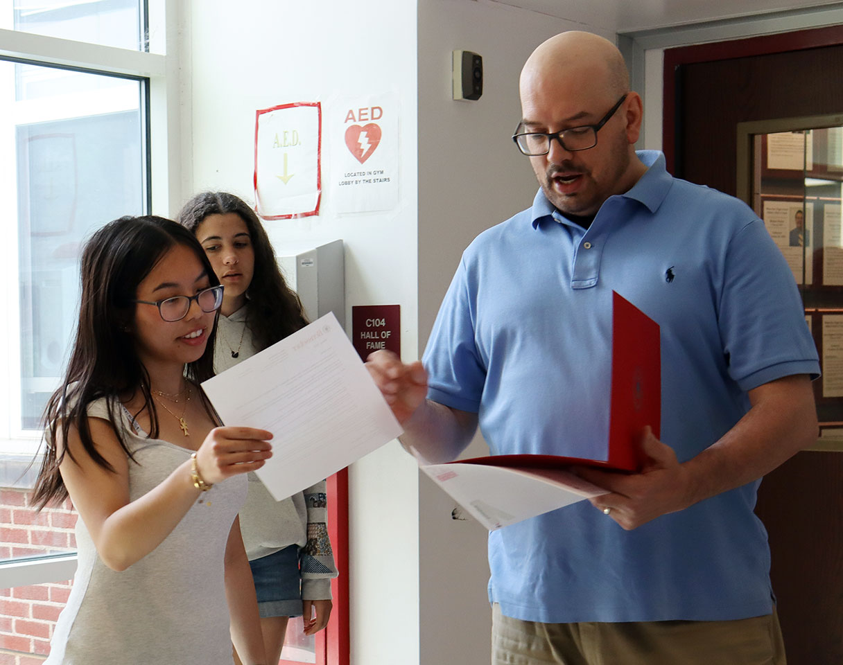 Teacher presents science scholarship award to student