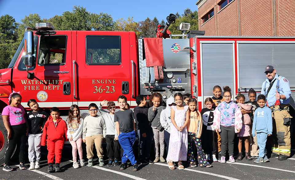 Students gather around a Watervliet fire truck