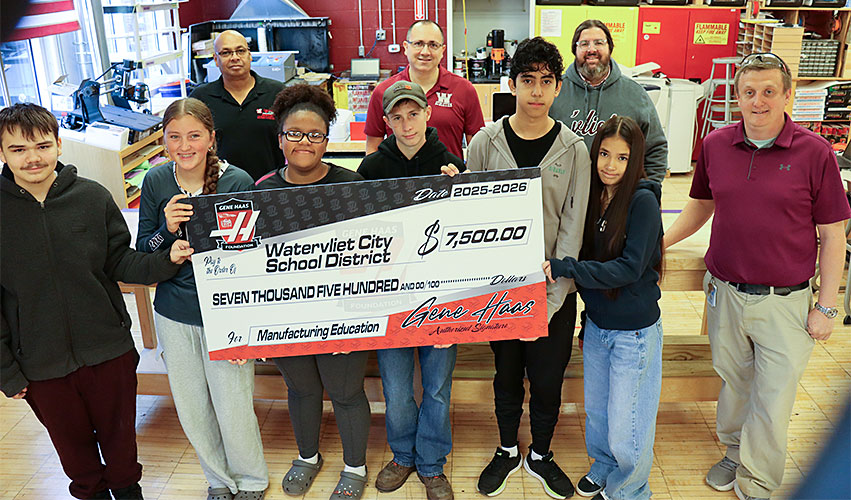 Students hold ceremonial check from the Gene Haas Foundation that was awarded to the school for the purchase of new technology
