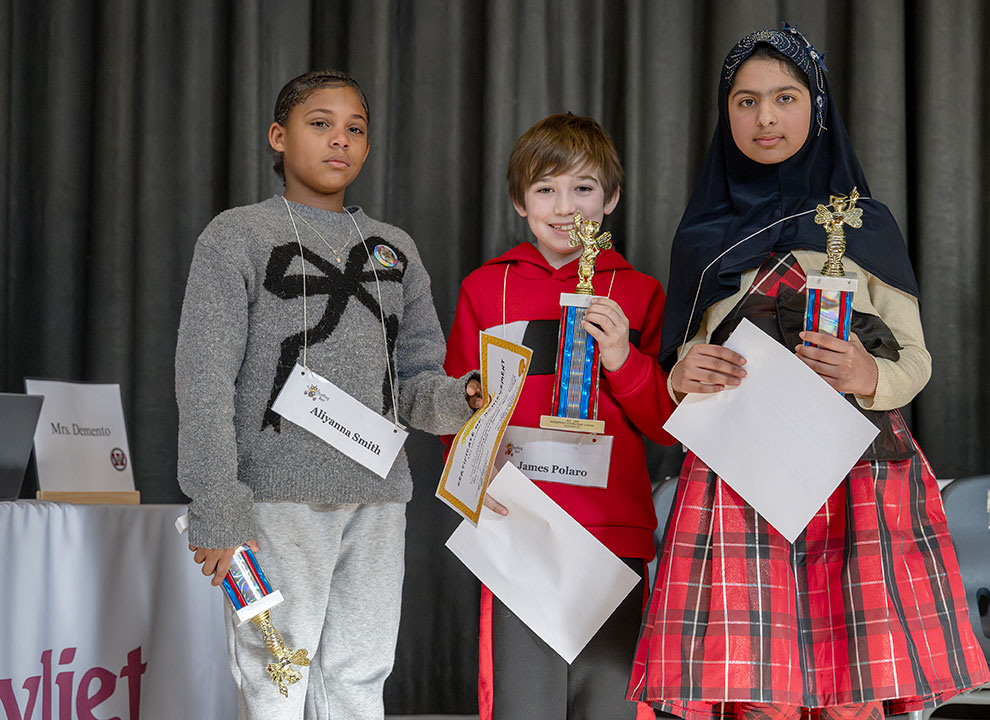 Top three spellers hold trophies and certificates