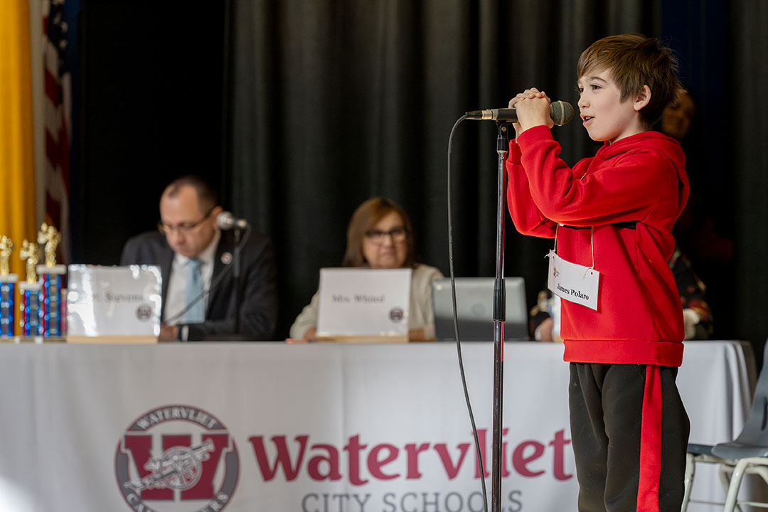 Spelling bee runner up speaks into microphone during competition