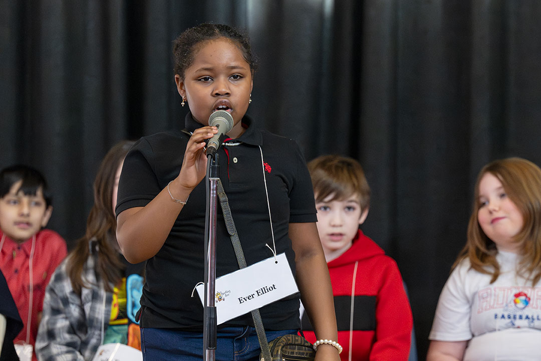 A speller speaks into the microphone during the spelling bee