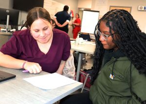 Watervliet student sits next to Career and Tech nursing student at Albany BOCES