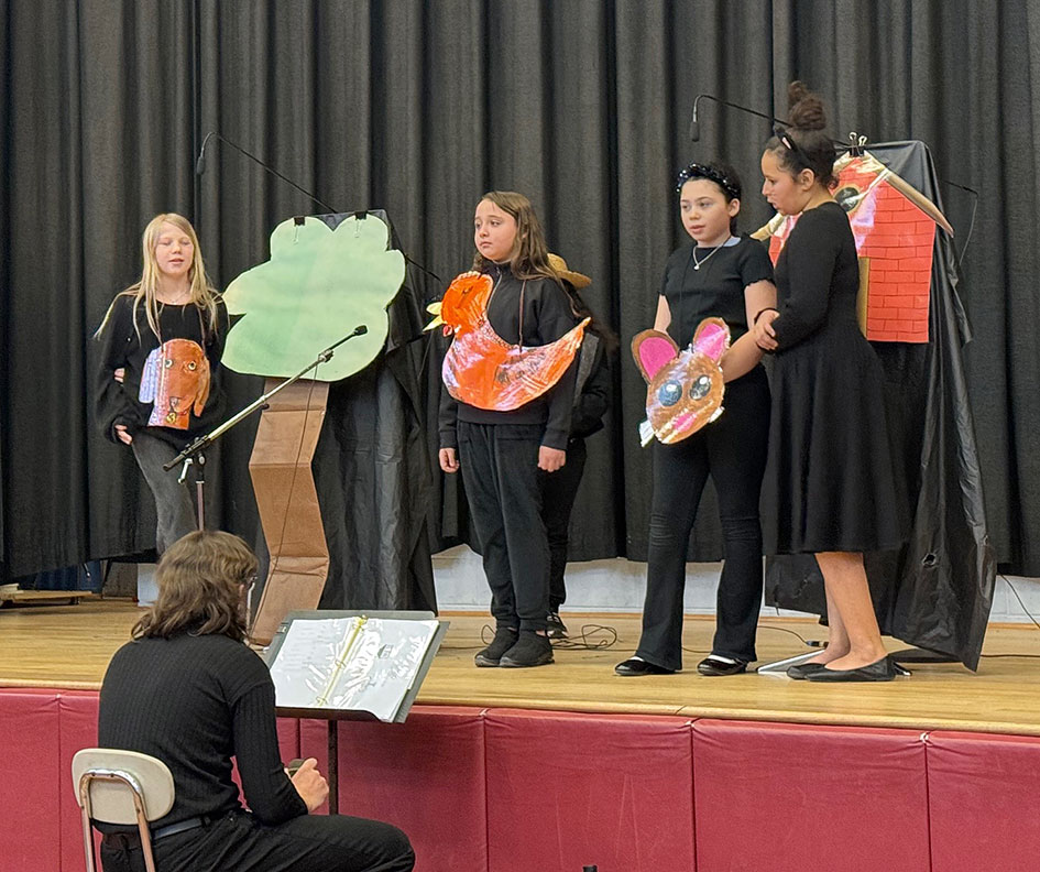 Group of students dressed in costume perform a skit on stage