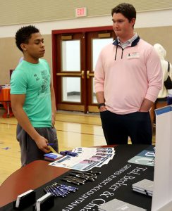 a high school student talking with a local professional from the finance industry