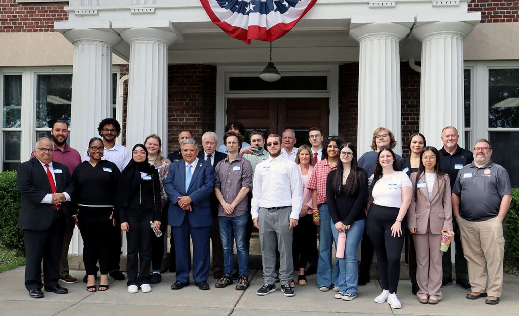 Students stand with city officials outside of City Hall