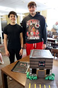 Two students stand near their collaborative city project display