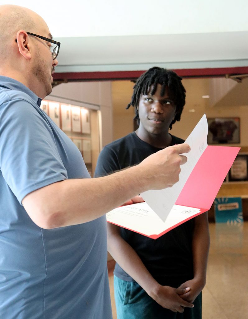 Science teacher presents scholarships to high school student