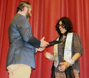 Watervliet student prepares to shake hands with Capital Region BOCES Career and Technical Education School principal at honor society induction