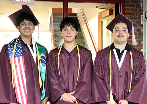Three graduates dressed in gaps and gowns