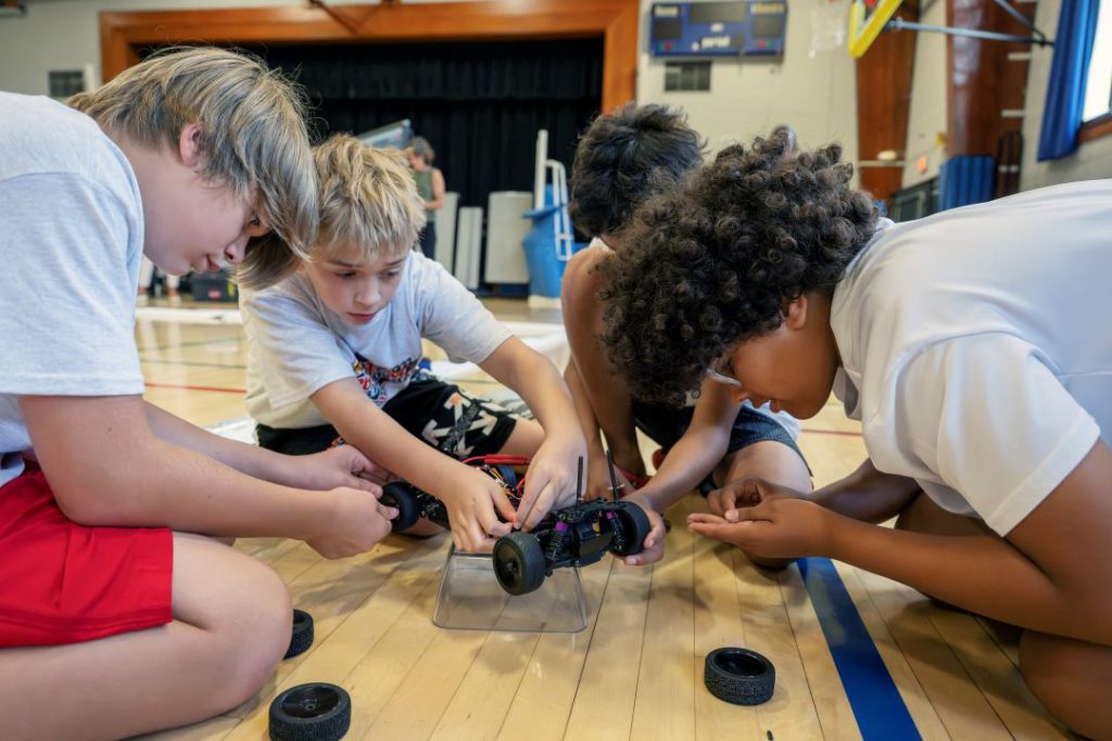 A team of students works on a remote control racecar
