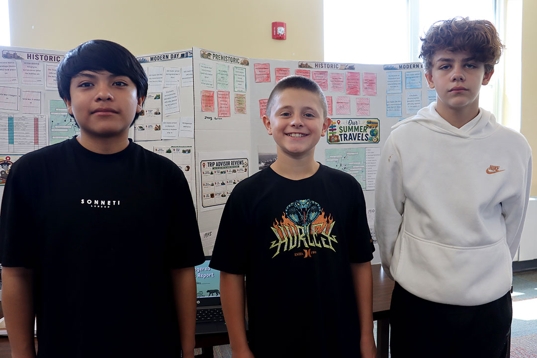 Students present their final projects on the Summer Travel Program to administrators, teachers and invited guests