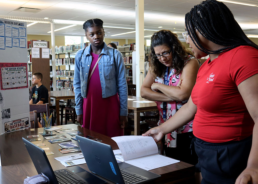 Students present their final projects on the Summer Travel Program to administrators, teachers and invited guests